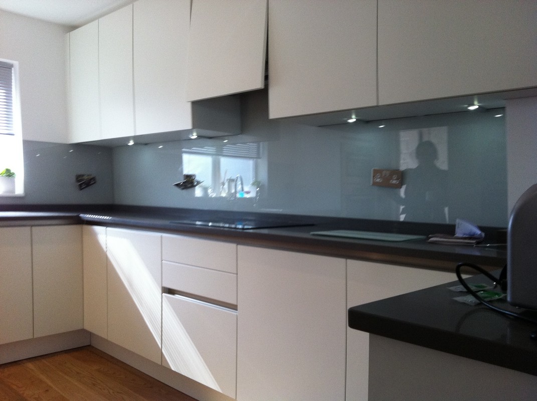Grey glass kitchen splashback with LED lighting in Caterham
