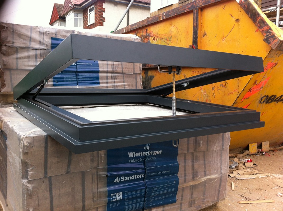 Opening flat roof skylight in anthracite grey installed in Caterham